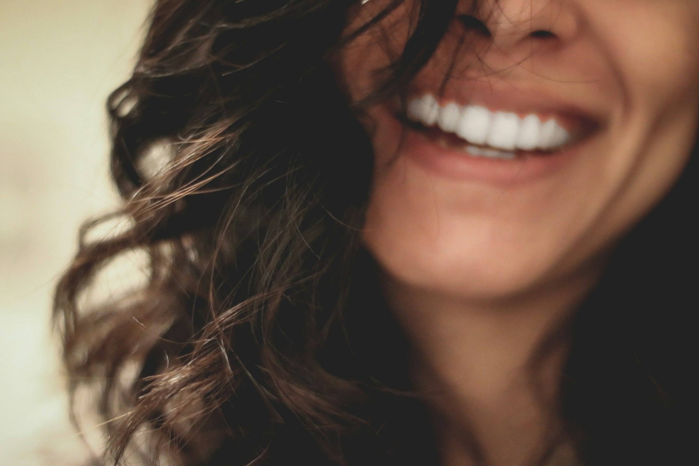 A woman smiling in natural light